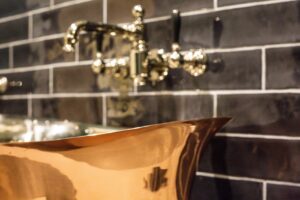 joes ensuite taps and brass bath closeup